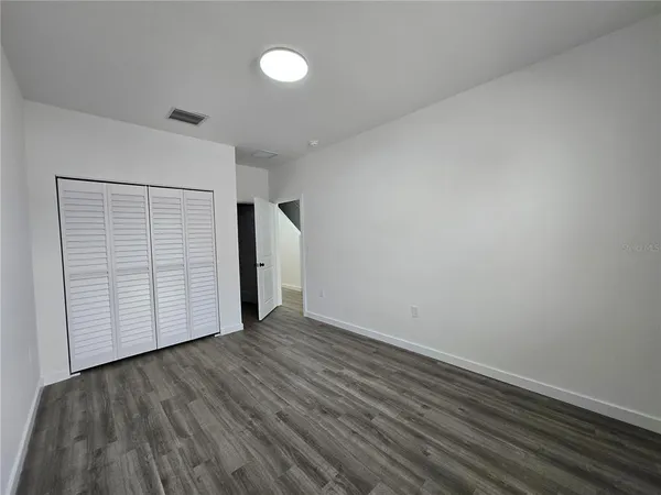 an empty room with wooden floor