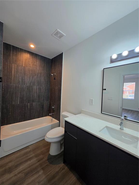 1601 Northwest 29 Road, Unit 3 Gainesville, FL 32605 - Photo 26 of 48 a bathroom with a sink a toilet a shower and a mirror