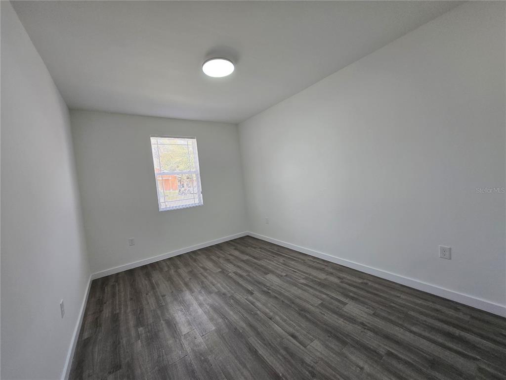 1601 Northwest 29 Road, Unit 3 Gainesville, FL 32605 - Photo 28 of 48 a view of an empty room and wooden floor