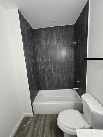 a bathroom with a toilet a sink and bathtub