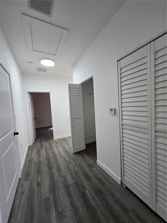 a view of wooden floor and windows in a room