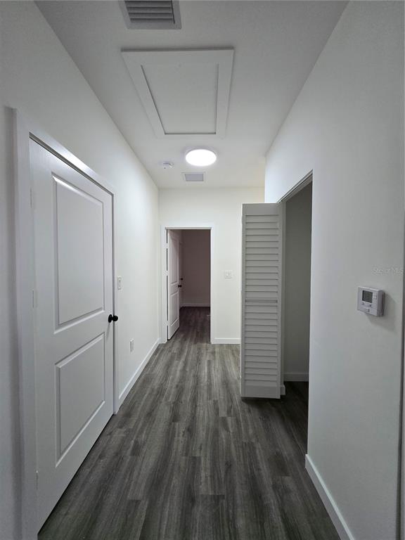 1601 Northwest 29 Road, Unit 3 Gainesville, FL 32605 - Photo 41 of 48 a view of wooden floor and windows in a room