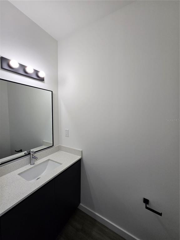 1601 Northwest 29 Road, Unit 3 Gainesville, FL 32605 - Photo 43 of 48 a bathroom with a sink and a mirror