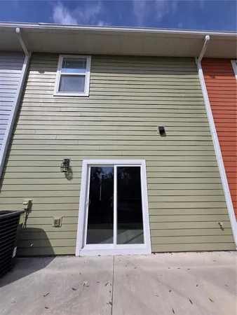a view of a house with a swimming pool and a large tree