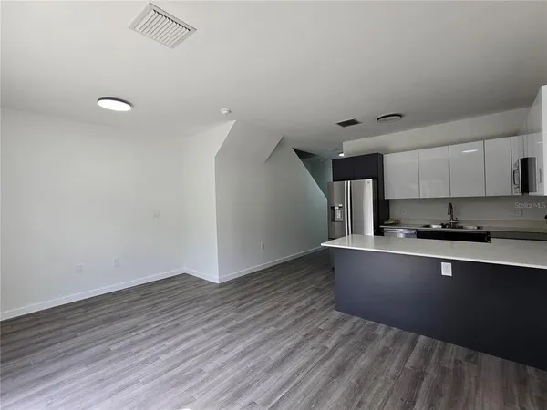 a kitchen with wooden floor and window
