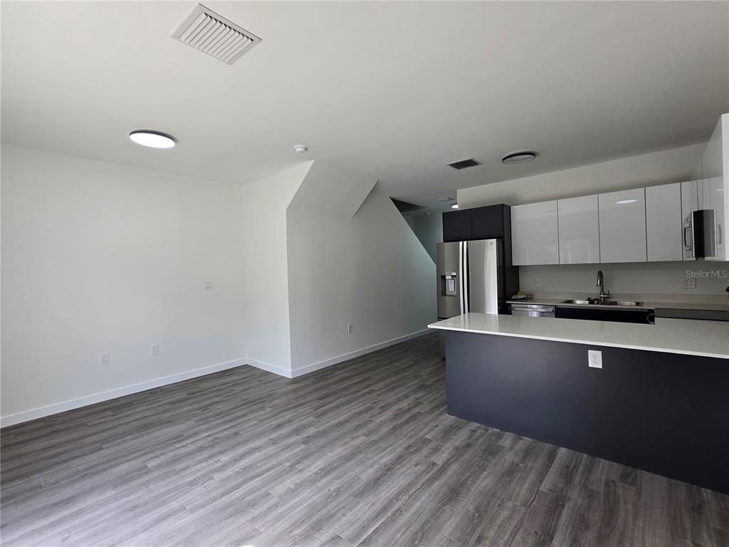 1601 Northwest 29 Road, Unit 3 Gainesville, FL 32605 - Photo 5 of 48 a kitchen with wooden floor and window
