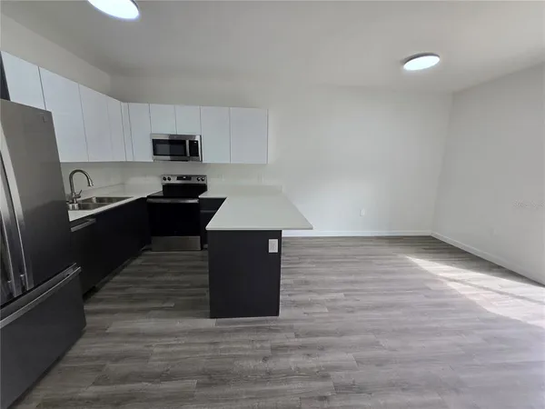 a kitchen with stainless steel appliances a refrigerator sink and stove