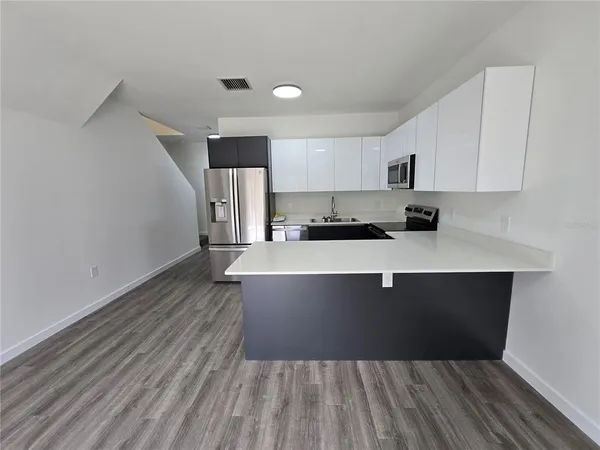 a view of kitchen and kitchen with a sink