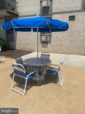 a patio with a table and chairs