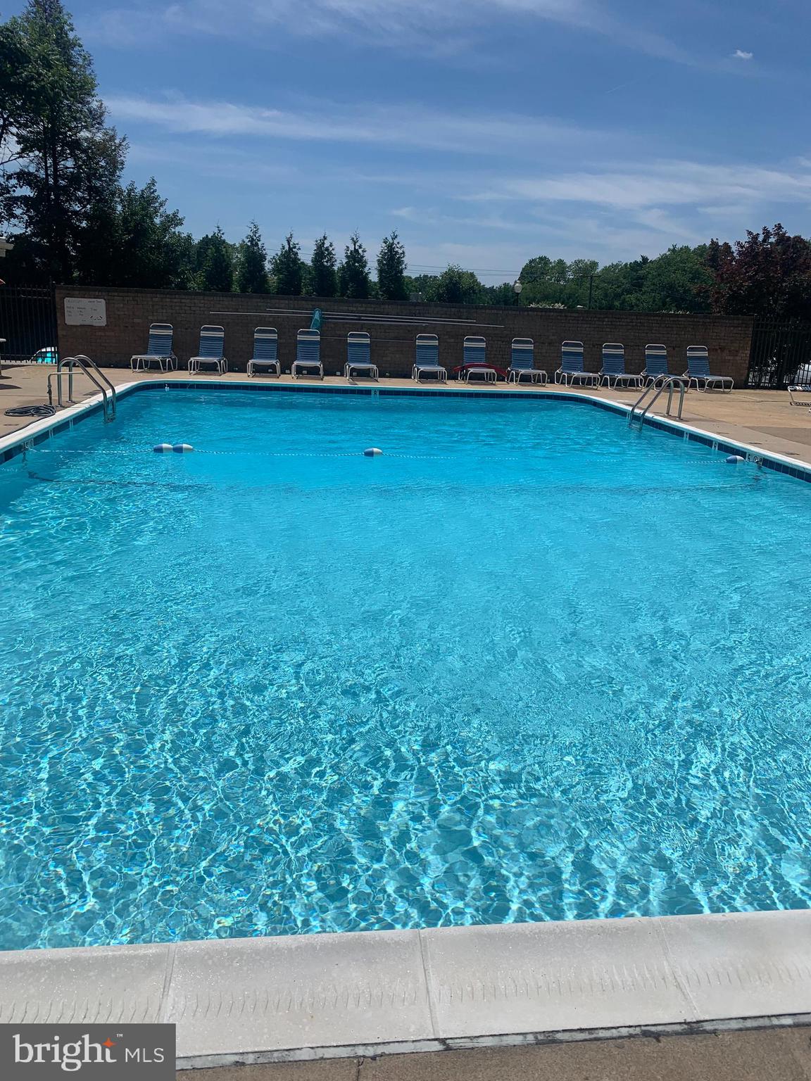 3245 Rio Drive, Unit 307 Falls Church, VA 22041 - Photo 14 of 39 a view of swimming pool with outdoor seating and yard in back
