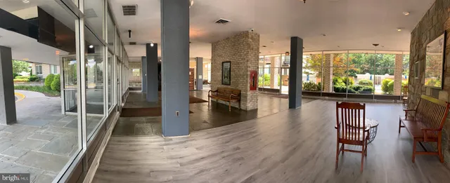 a view of a large hall with a dining table chairs
