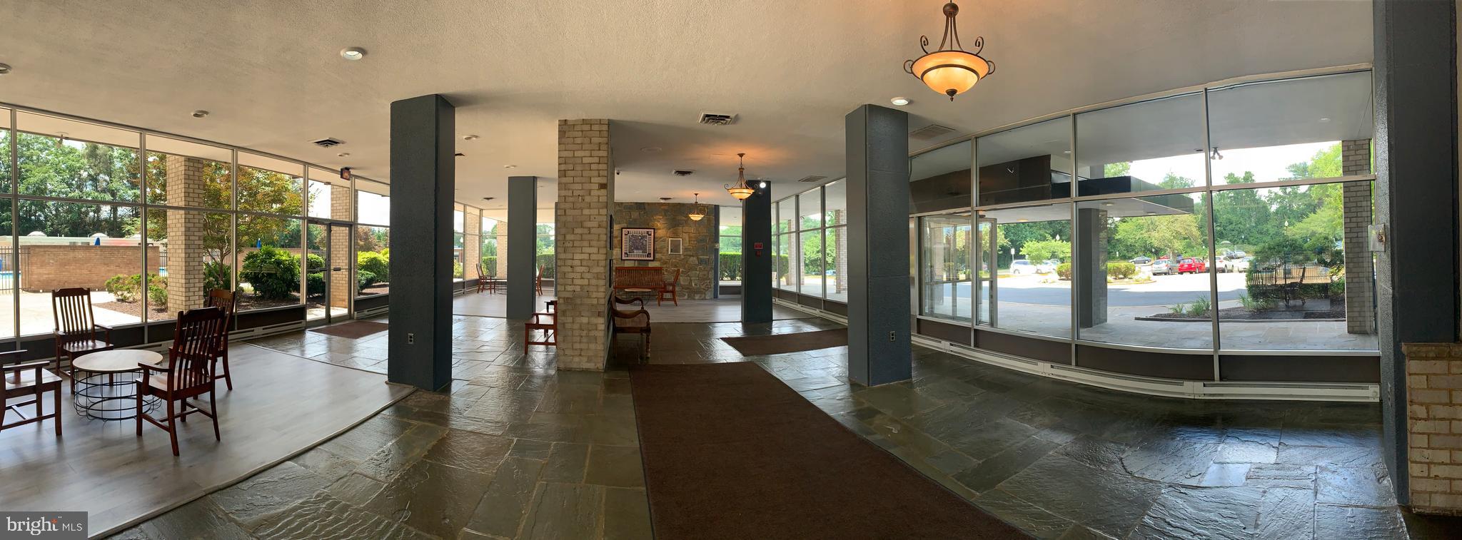 3245 Rio Drive, Unit 307 Falls Church, VA 22041 - Photo 25 of 39 a view of a large hall with a dining table chairs