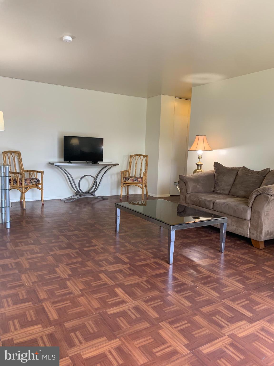 3245 Rio Drive, Unit 307 Falls Church, VA 22041 - Photo 30 of 39 a living room with furniture and a flat screen tv