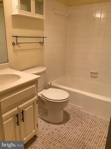 a bathroom with a toilet and a bathtub