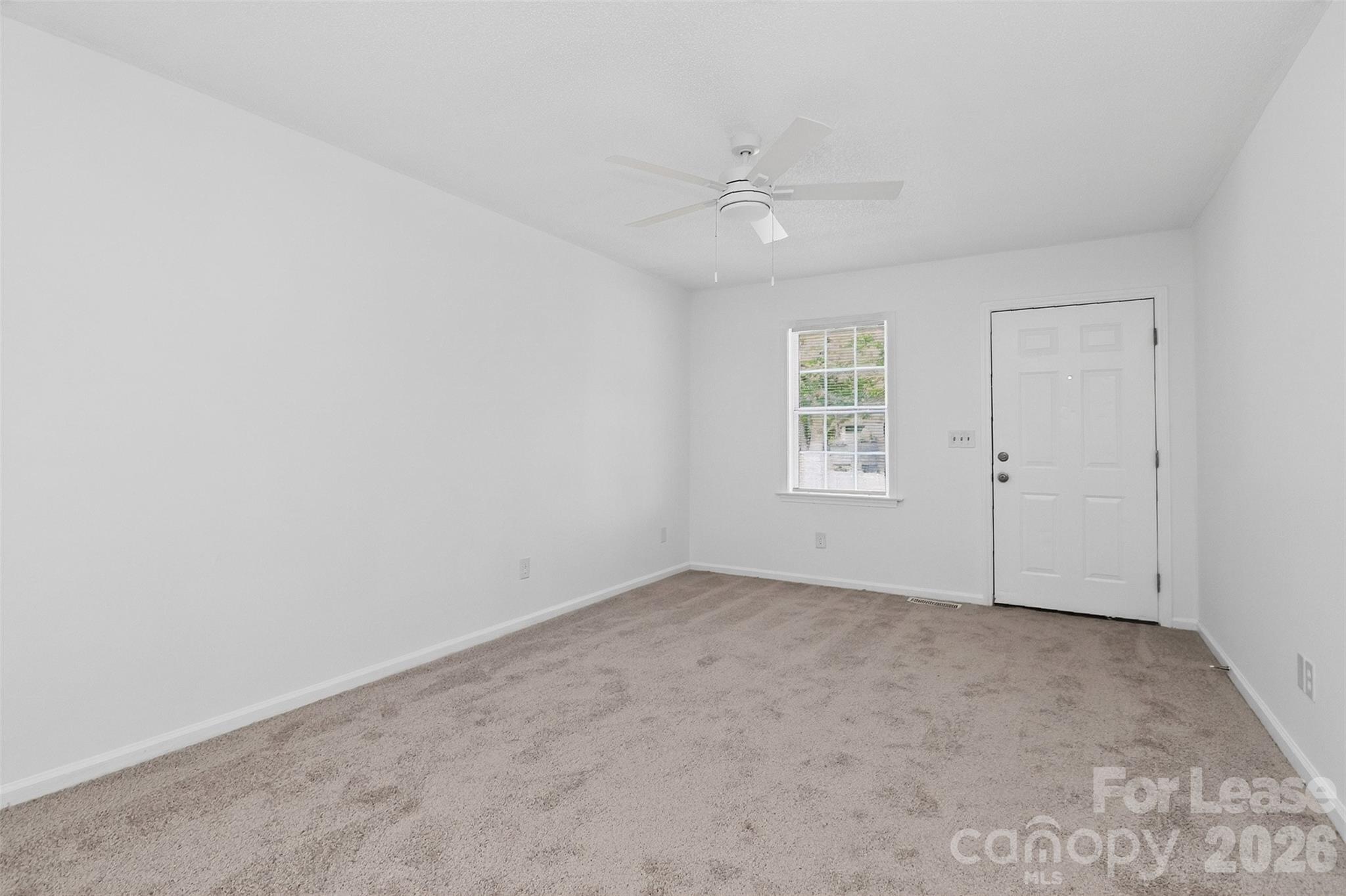 91-93 Sunderland Road Southwest, Unit 93 Concord, NC 28027 - Photo 10 of 30 an empty room with a window and ceiling fan