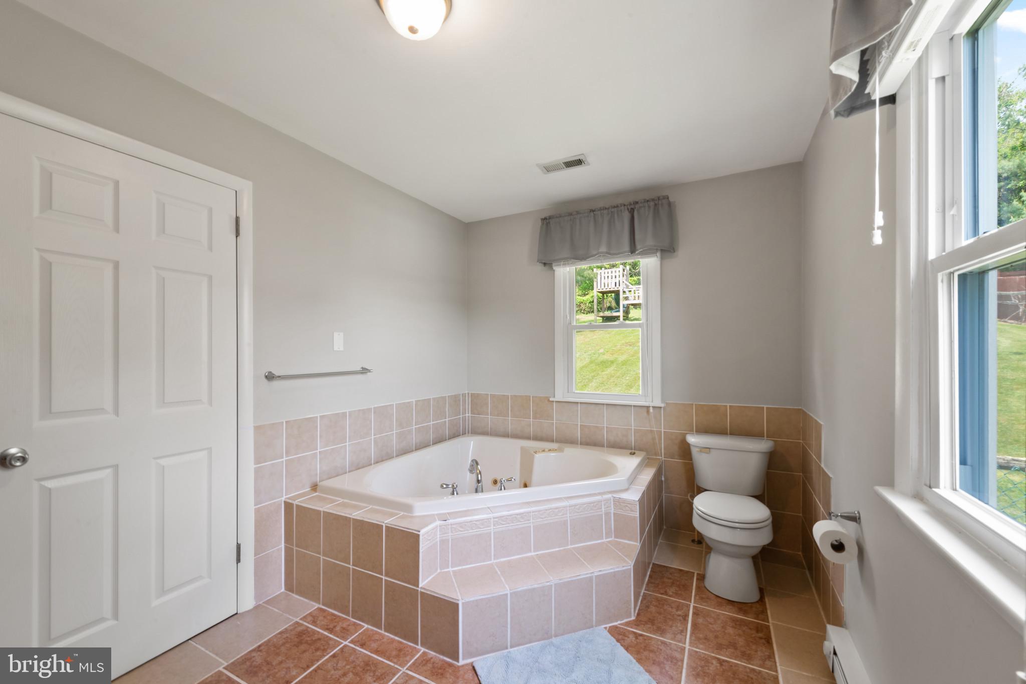 3242 Lineboro Road Manchester, MD 21102 - Photo 21 of 30 a white bath tub sitting next to a window