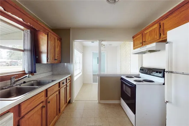 a kitchen that has a sink and a stove