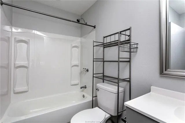 a bathroom with a shower toilet and sink