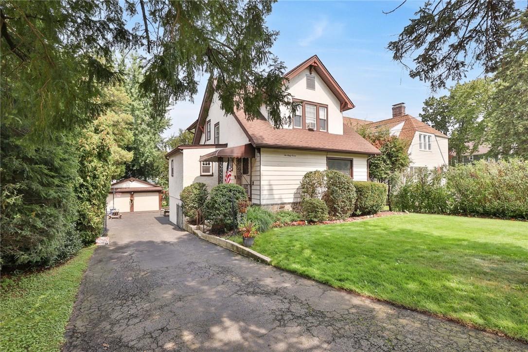 267 Eastchester Road New Rochelle, NY 10801 - Photo 1 of 1 a front view of a house with a yard and trees