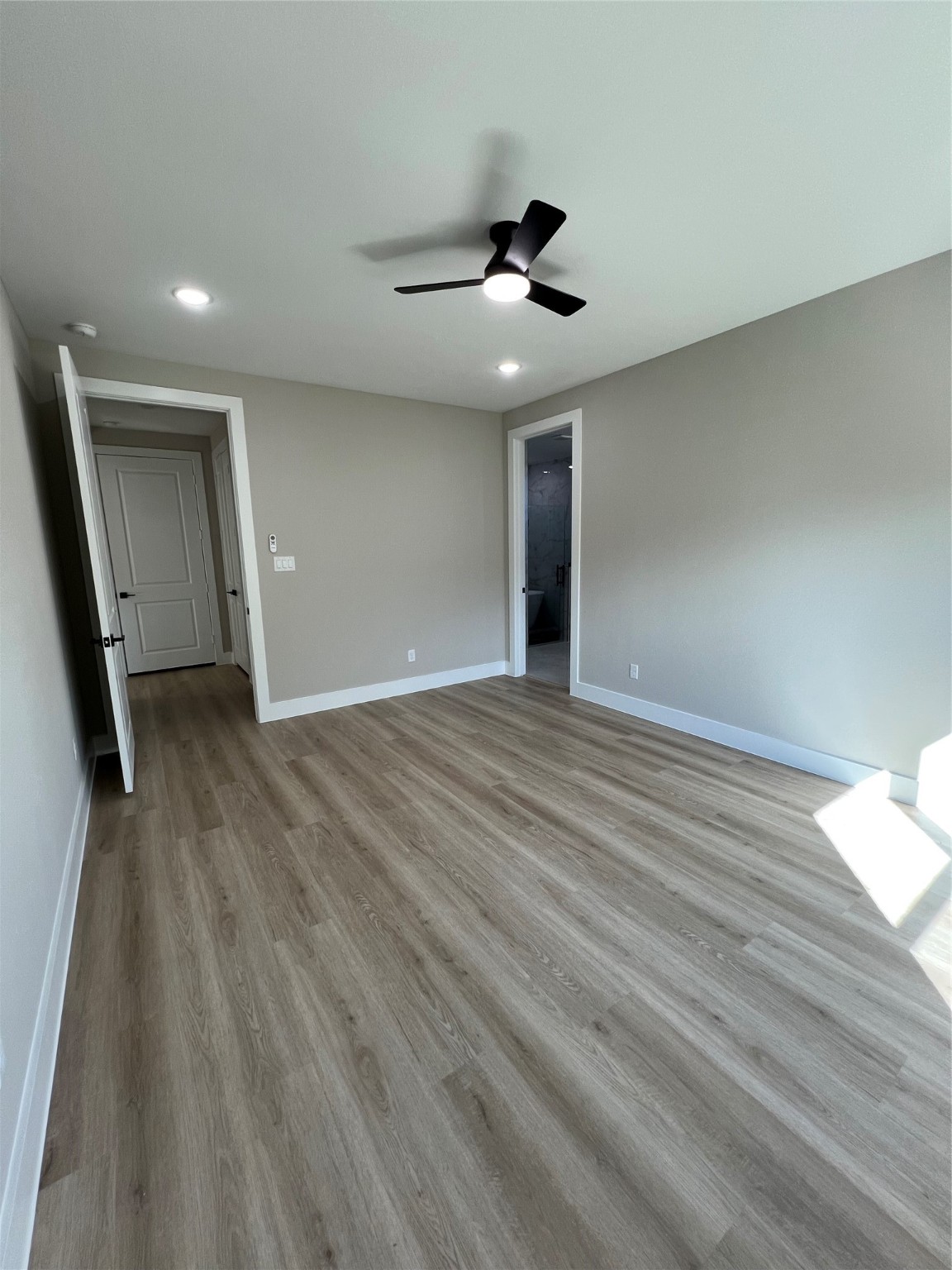 2603 Piemonte Ct Ave Spring Spring, TX 77388 - Photo 18 of 30 a view of an empty room with wooden floor and a ceiling fan