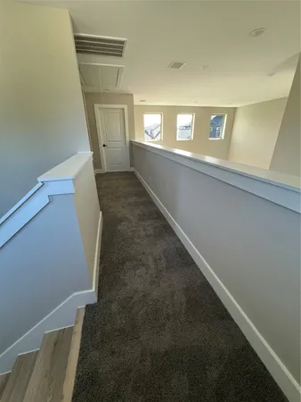 a view of an empty room with windows