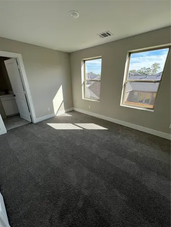 a view of hallway with window and stairs