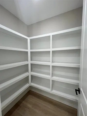 a view of walk in closet with empty racks