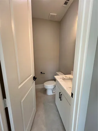 a bathroom with a toilet a sink and a vanity