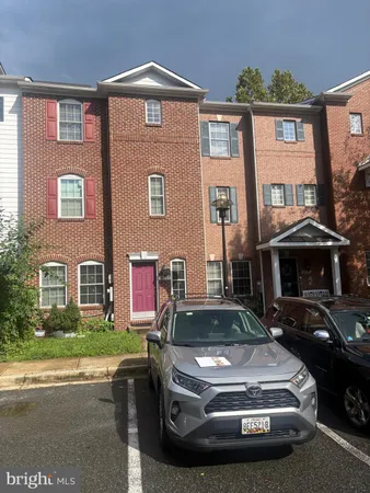 a view of a car parked in front of a brick house