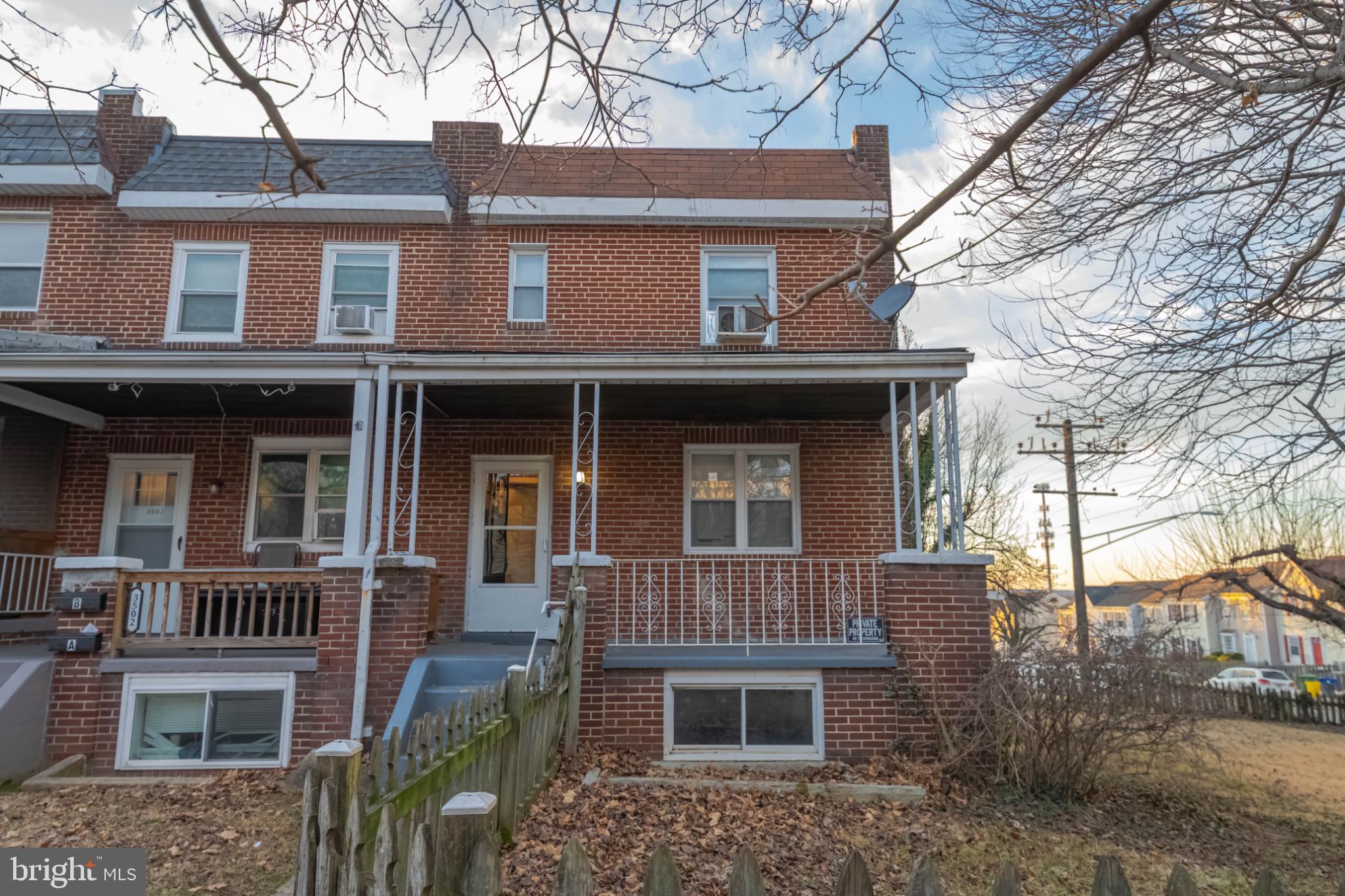 Charming brick townhouse with inviting porch.