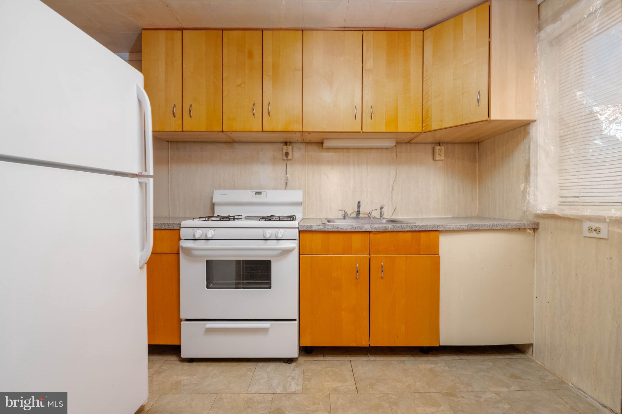 3500 4th Street Baltimore, MD 21225 - Photo 5 of 43 Cozy kitchen with warm wooden cabinetry.