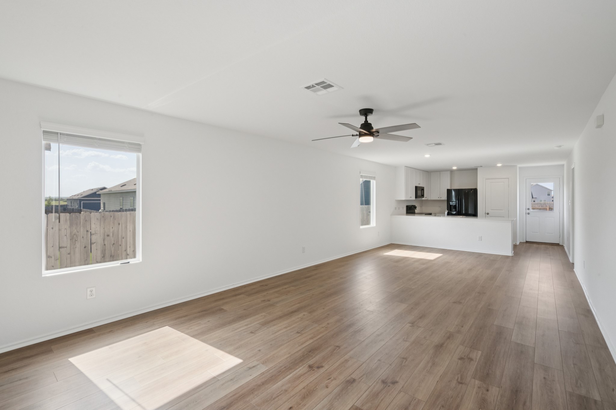 505 Sergeant Murphy Road Jarrell, TX 76537 - Photo 11 of 16 a view of a livingroom with wooden floor and a ceiling fan