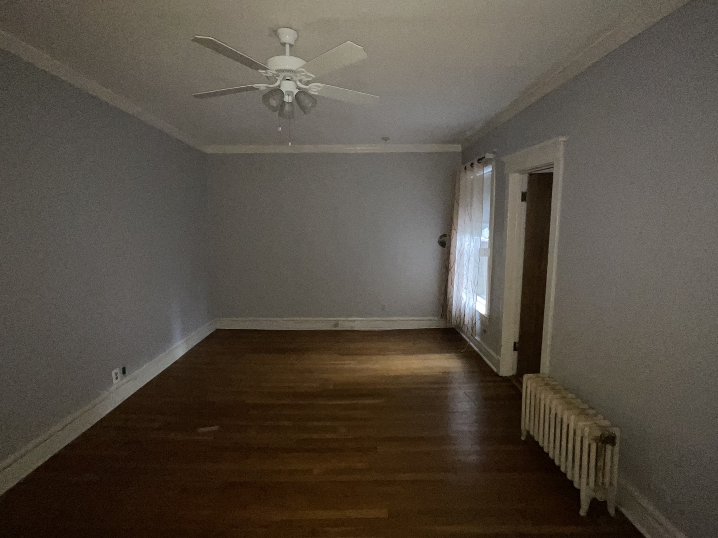 5488 South Everett Avenue, Unit 2 Chicago, IL 60615 - Photo 17 of 29 an empty room with wooden floor and fan