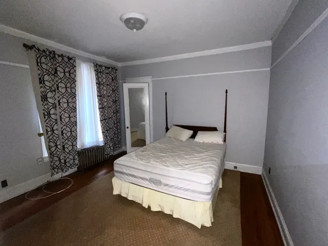 a bedroom with bed and window