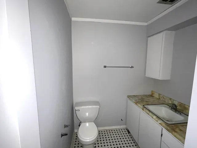 an empty room with wooden floor and entrance