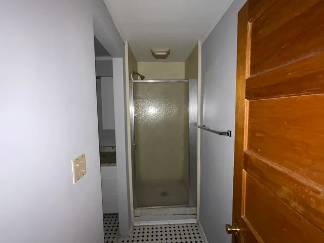 a bedroom with bed and a flat screen tv