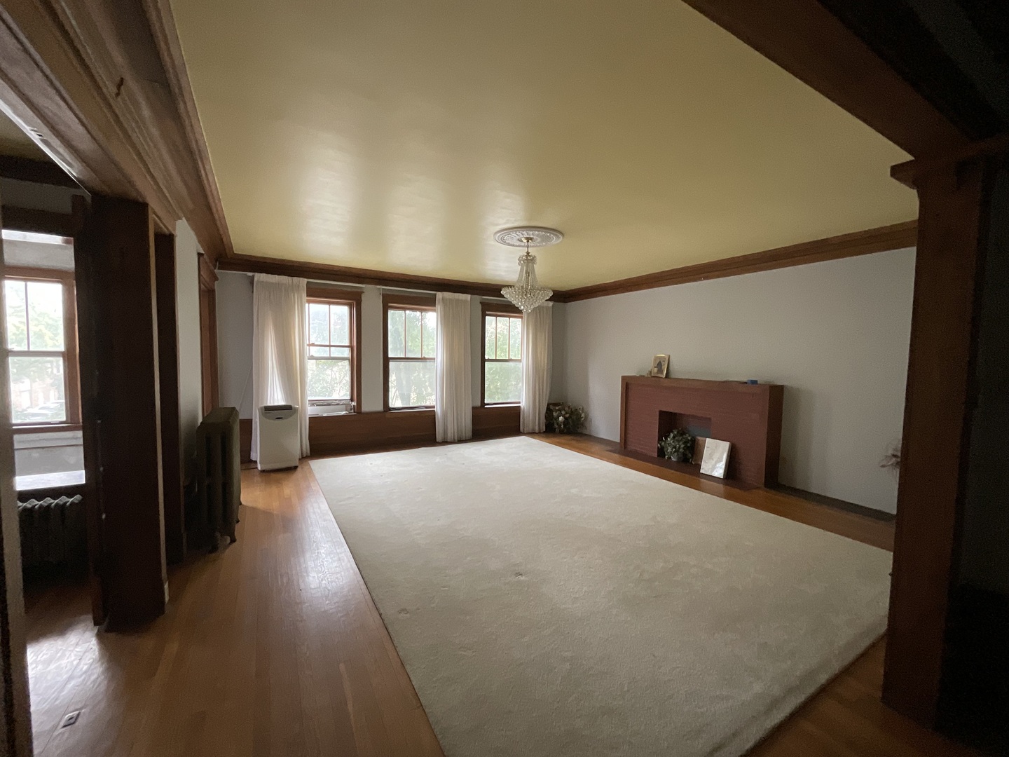 5488 South Everett Avenue, Unit 2 Chicago, IL 60615 - Photo 4 of 29 a large bedroom with a bed and wooden floor