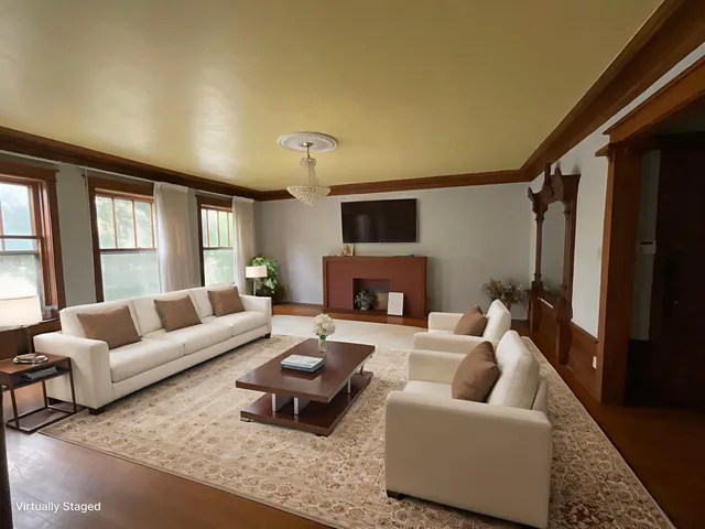 a living room with furniture a fireplace and a flat screen tv