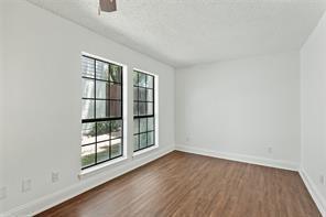 9524 Military Parkway, Unit 5002 Dallas, TX 75227 - Photo 10 of 11 wooden floor in an empty room with a window