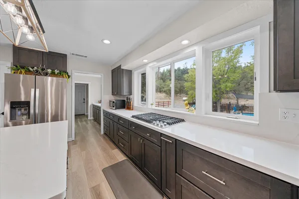 a view of a workspace with furniture and a window