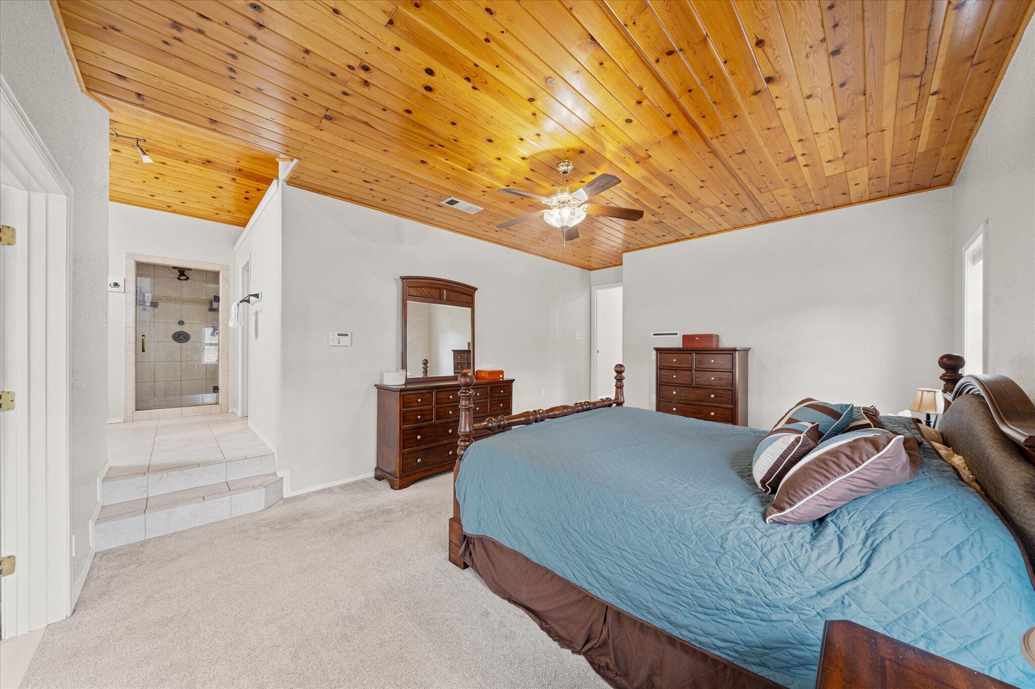10190 Oak Run Road Oak Run, CA 96069 - Photo 23 of 78 a bedroom with a bed and a chandelier