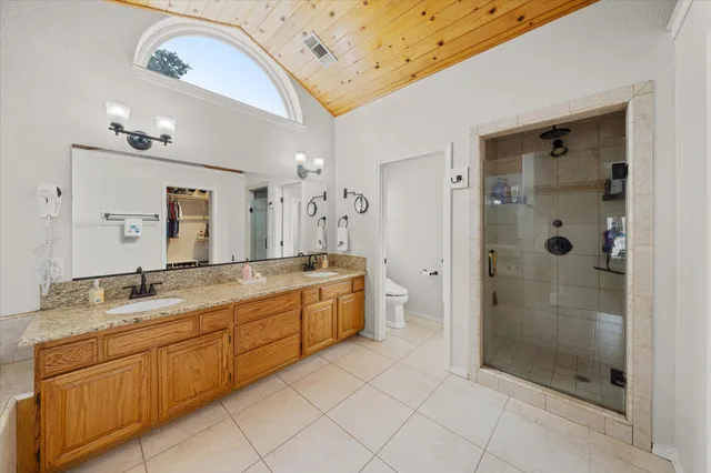 a view of a patio with table and chairs and wooden fence