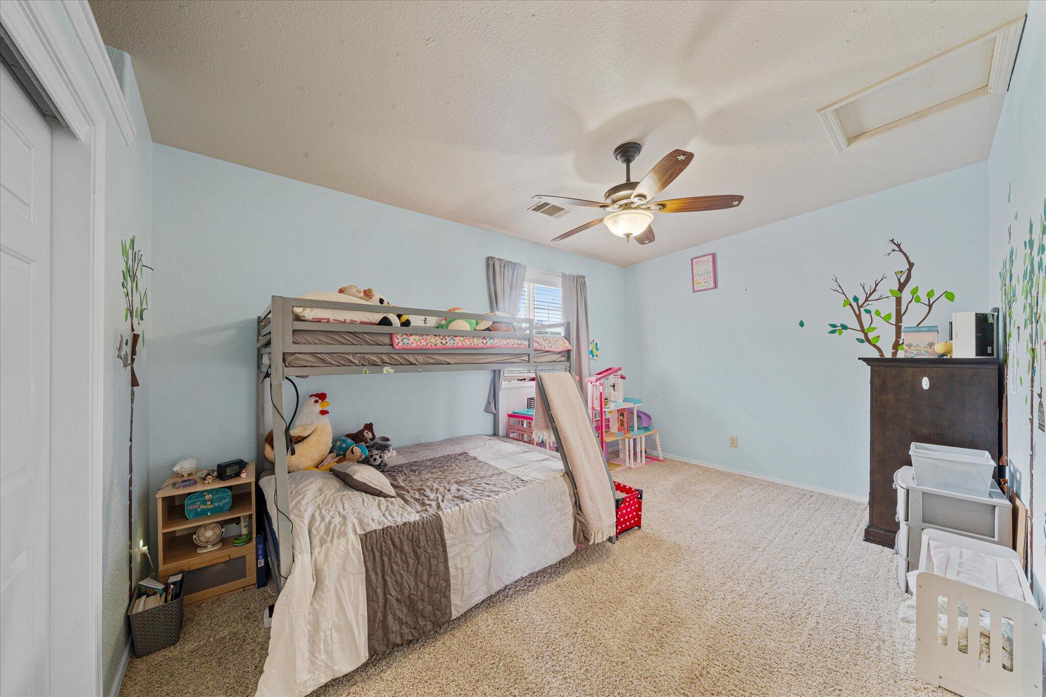 10190 Oak Run Road Oak Run, CA 96069 - Photo 37 of 78 a bedroom with a bed and a chandelier