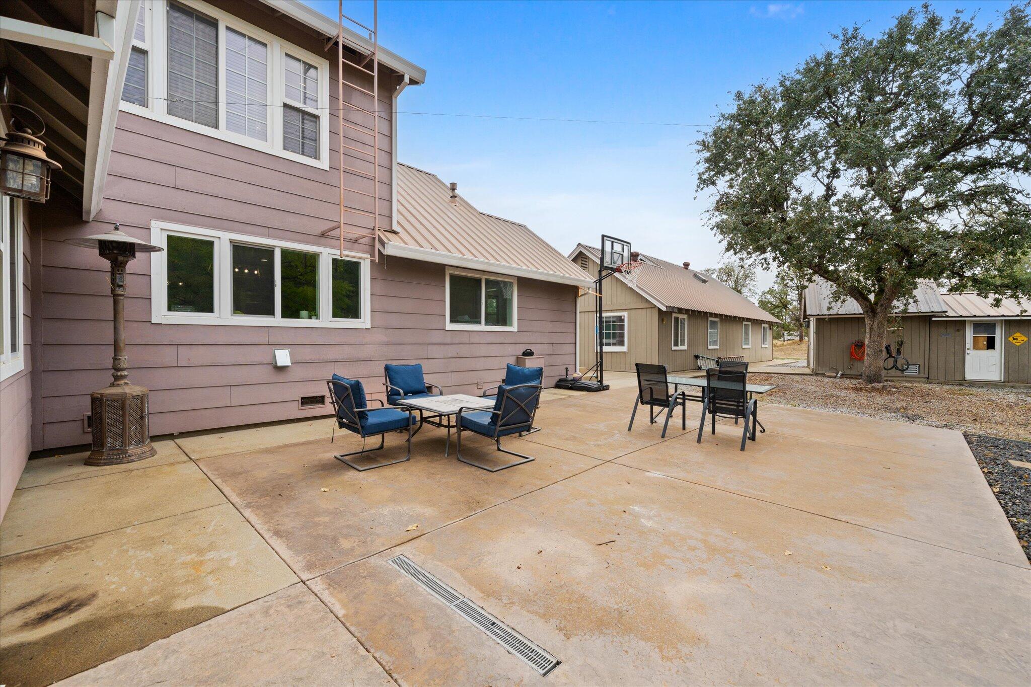 10190 Oak Run Road Oak Run, CA 96069 - Photo 50 of 78 a view of a patio with table and chairs and wooden fence