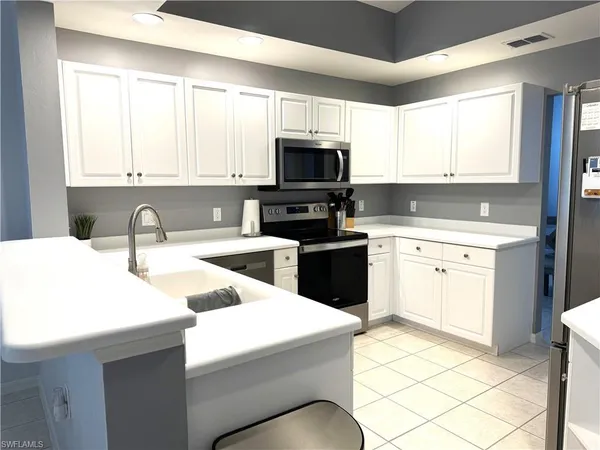 a kitchen with a sink stove and microwave