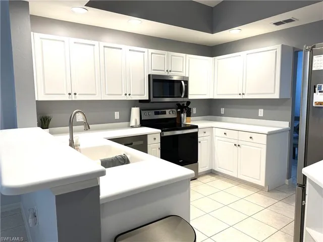 a kitchen with a sink stove and microwave