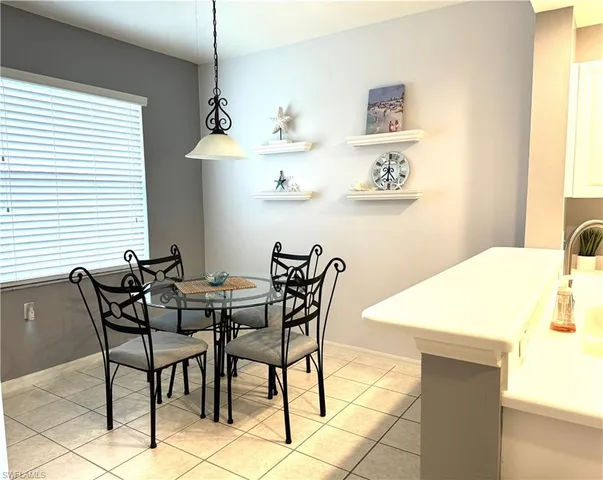 a view of a dining room with furniture and window