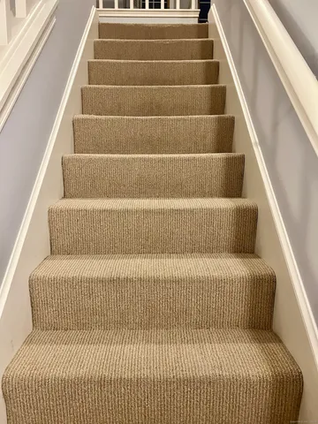 a bed sitting in a bedroom next to a cabinet