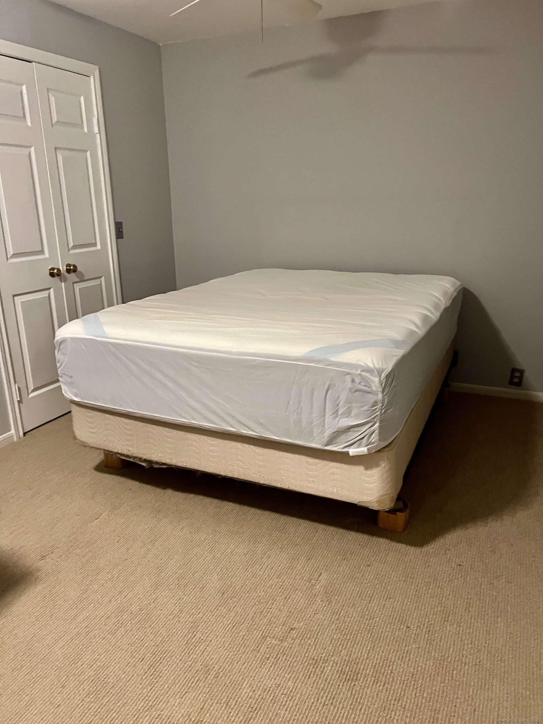 523 Old Pond Lane, Unit 523 Norwich, CT 06360 - Photo 12 of 25 a bed sitting in a bedroom next to a cabinet