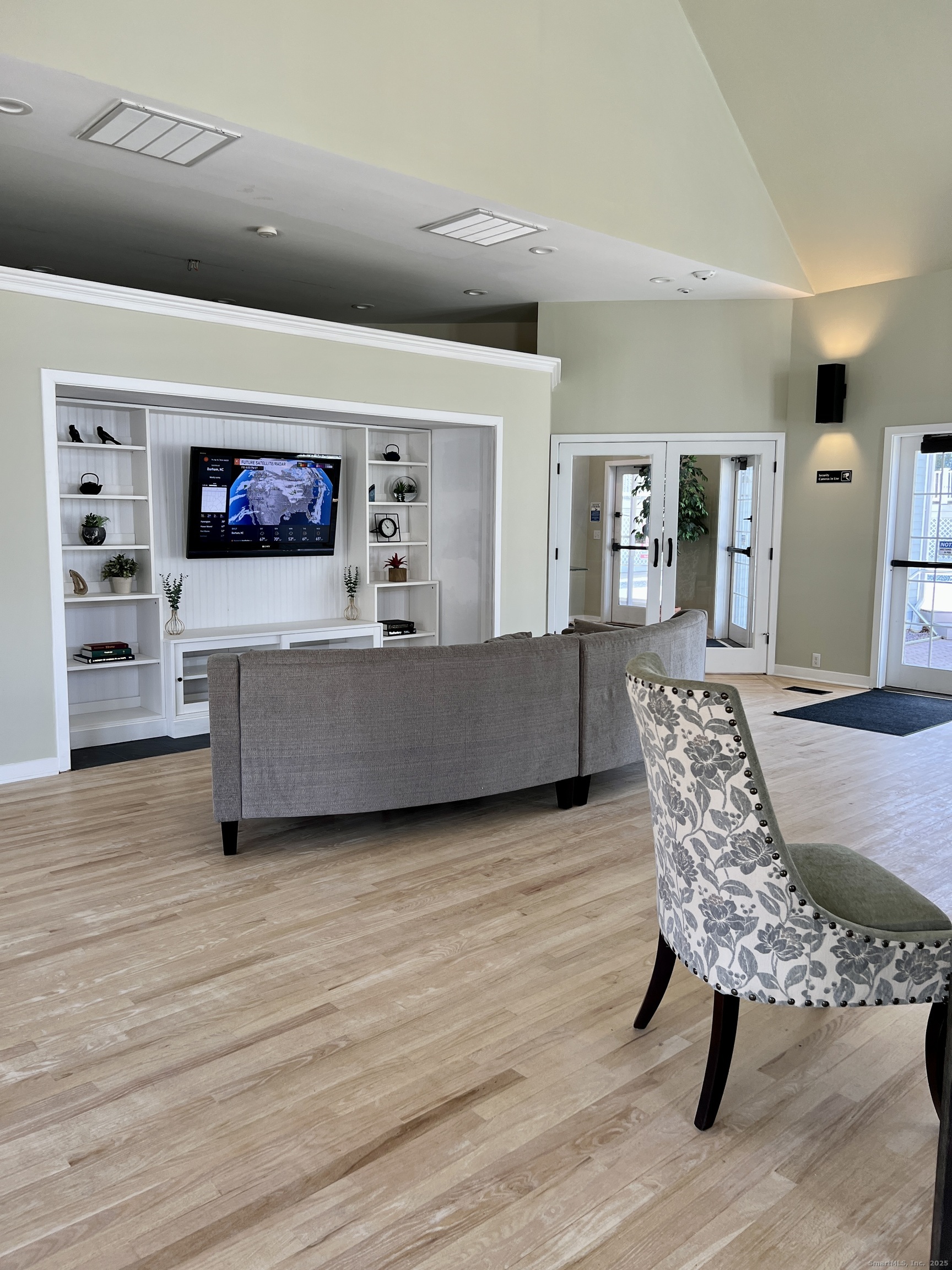 523 Old Pond Lane, Unit 523 Norwich, CT 06360 - Photo 17 of 25 a living room with furniture and a flat screen tv